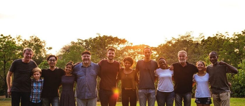 Group of Diverse People Sunset Grass Field