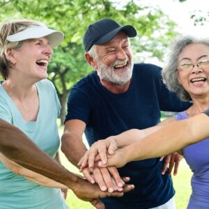 Diverse group of older adults with hands together
