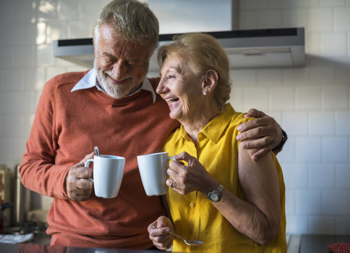 Older adult couple having coffee and laughing
