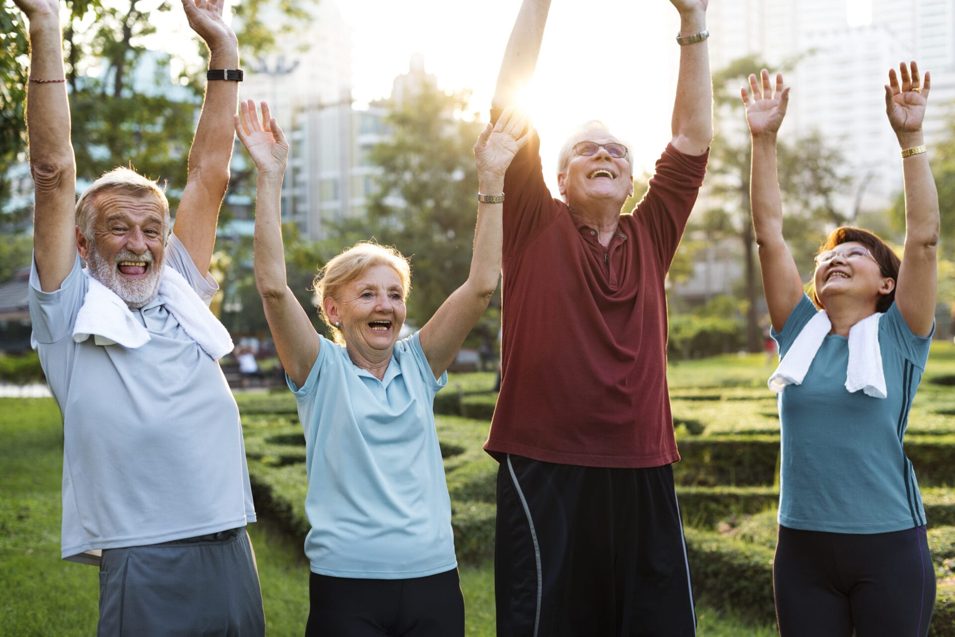 Older-people-workout-hands-up-1920×1281 older adults outdoor workout hands up